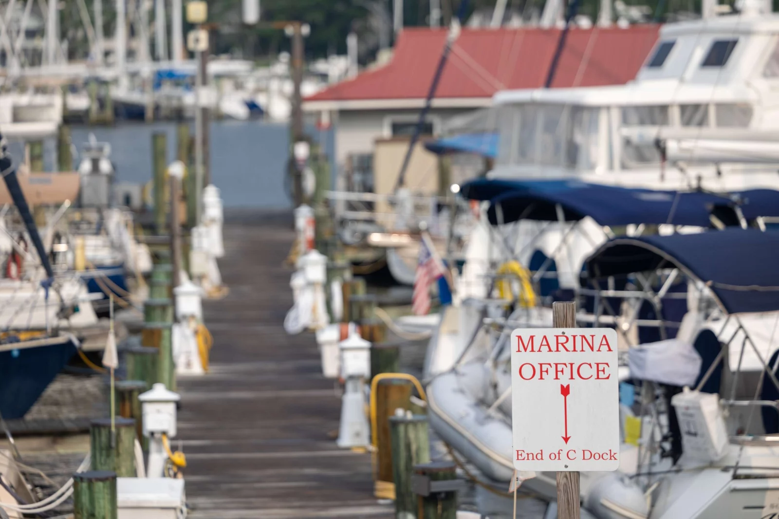 Marina Office Dock Sign with boats in the background